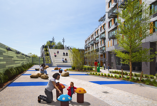 Children’s play area is designed with safety surface located in the courtyard.: At the heart of Via Verde are a series of gardens that begin in the courtyard then spiral up through a series of green roofs and south facing solar panels.The rooftop gardens dissipate heat and absorb rainwater runoff, using a reclamation system that recycles water for irrigation, while providing opportunities for active gardening, fruit and vegetable cultivation, relaxation and social gathering. The facade features aluminum, cement, and wood panels with panoramic windows, sunshades, and courtyard balconies. A landscaped courtyard, the green roofs, a fitness center, and day-lit stairs promote healthy lifestyles and provide opportunities for physical fitness.        Photograph © David Sundberg/ESTO